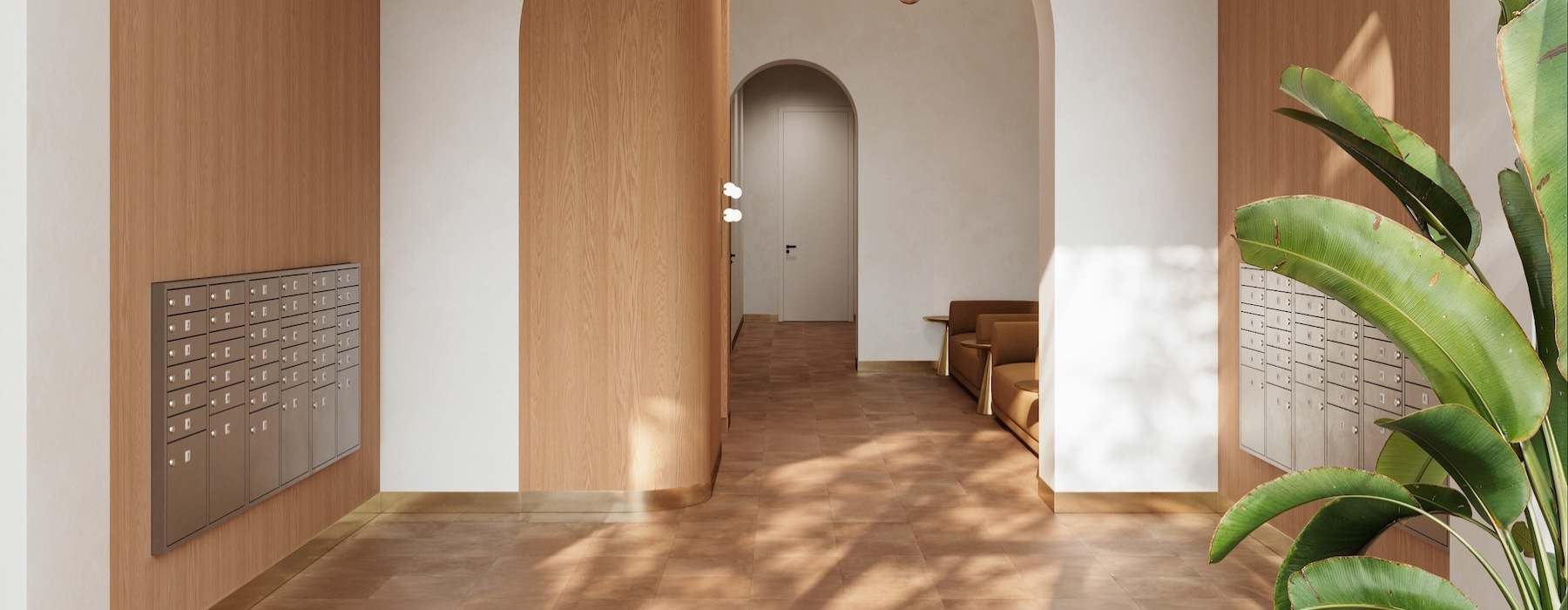 a lobby with mail lockers and a plant