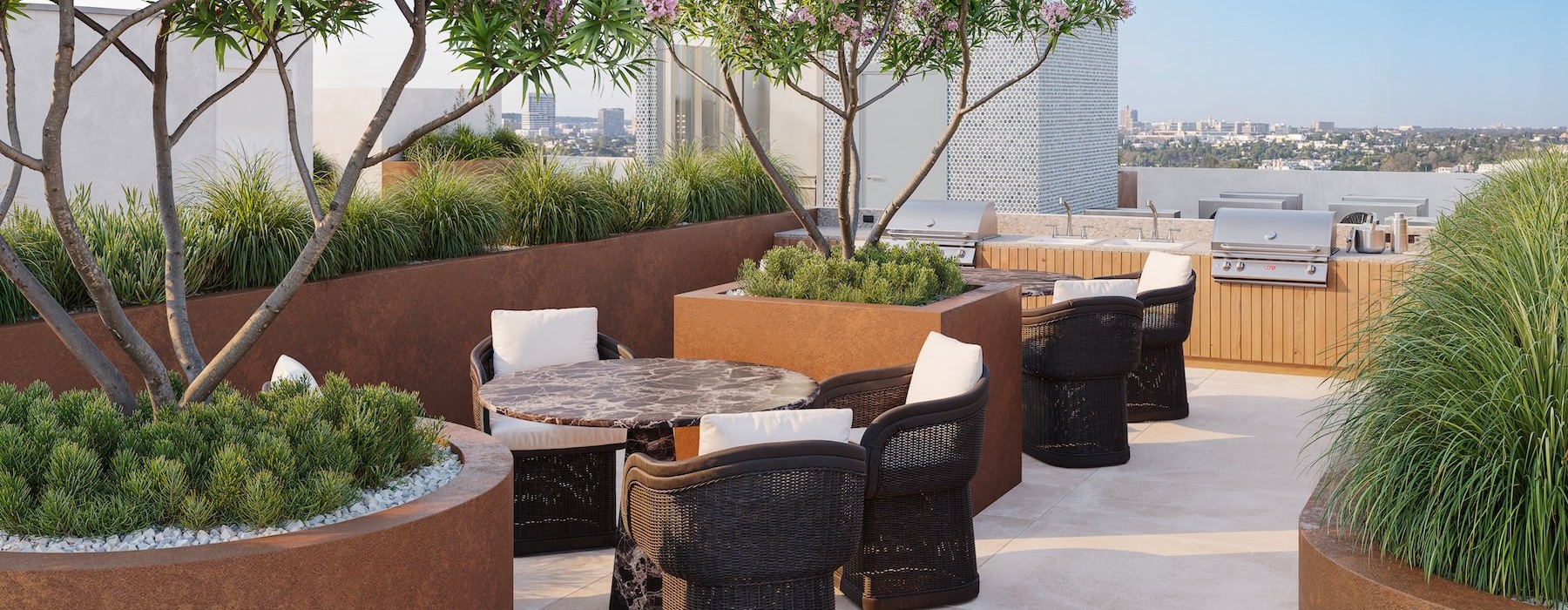 a patio with a table and chairs and a tree with flowers