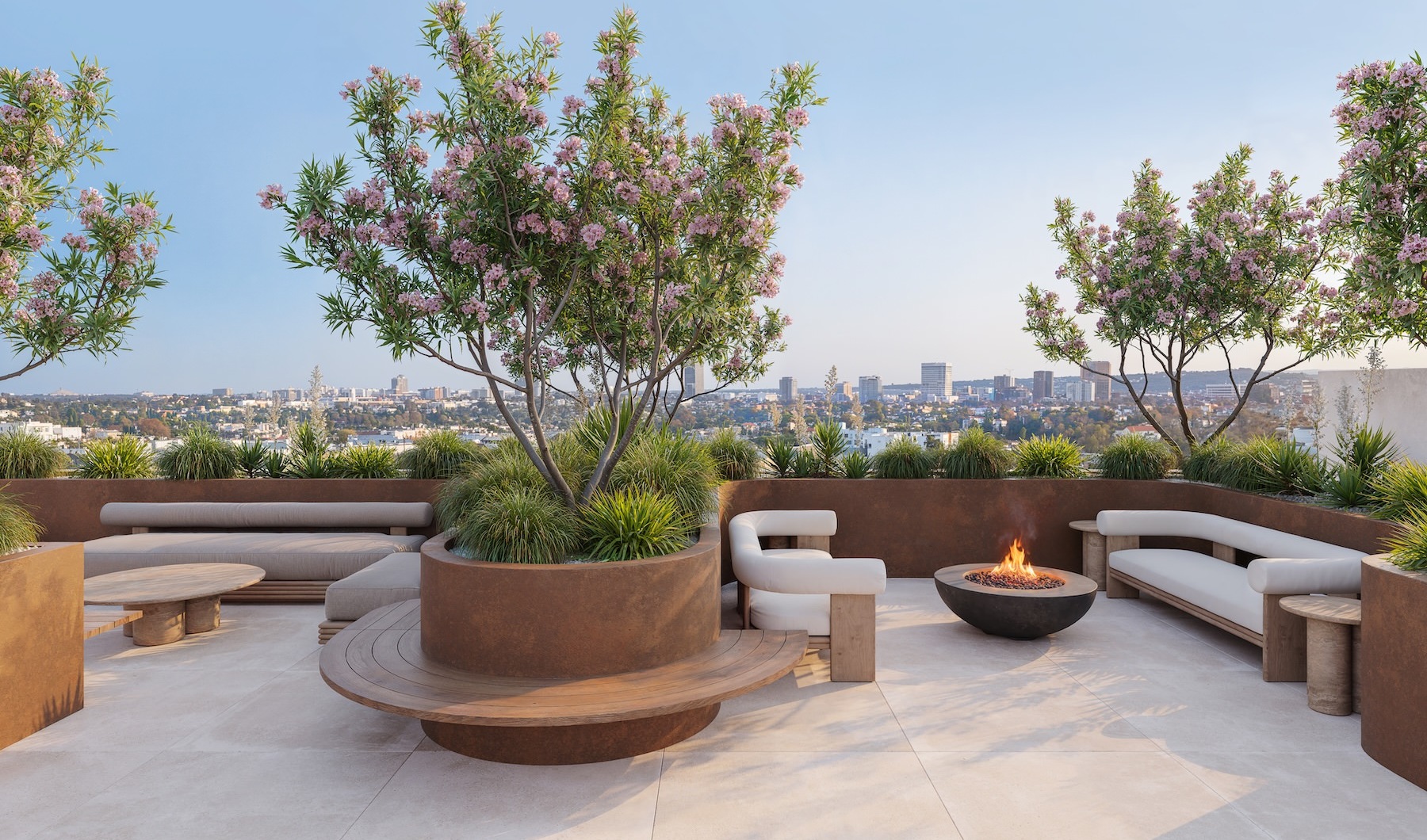 a courtyard with a fire pit, couches and plants